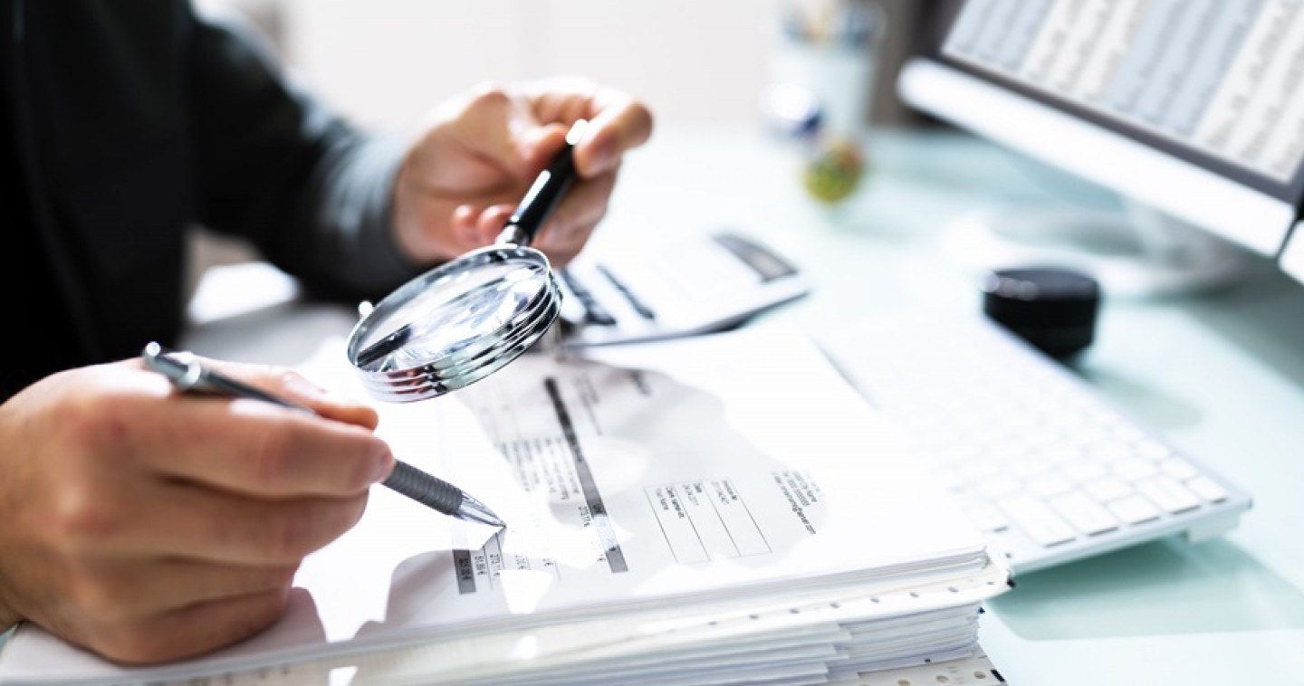 Audit And Fraud Investigation. Auditor Using Magnifying Glass